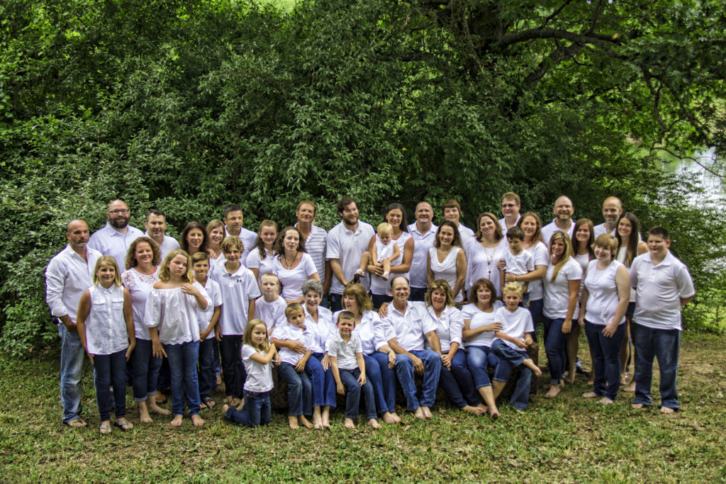 photo of family wearing white shirts and blue jeans to a photo shoot